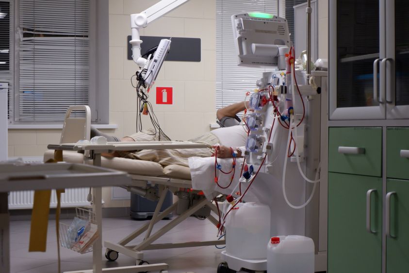 the patient is being treated with a hemodialysis procedure on an artificial kidney machine